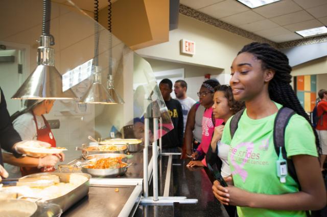 Student selecting food in the dining hall