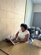 A student studies with a laptop at a desk.