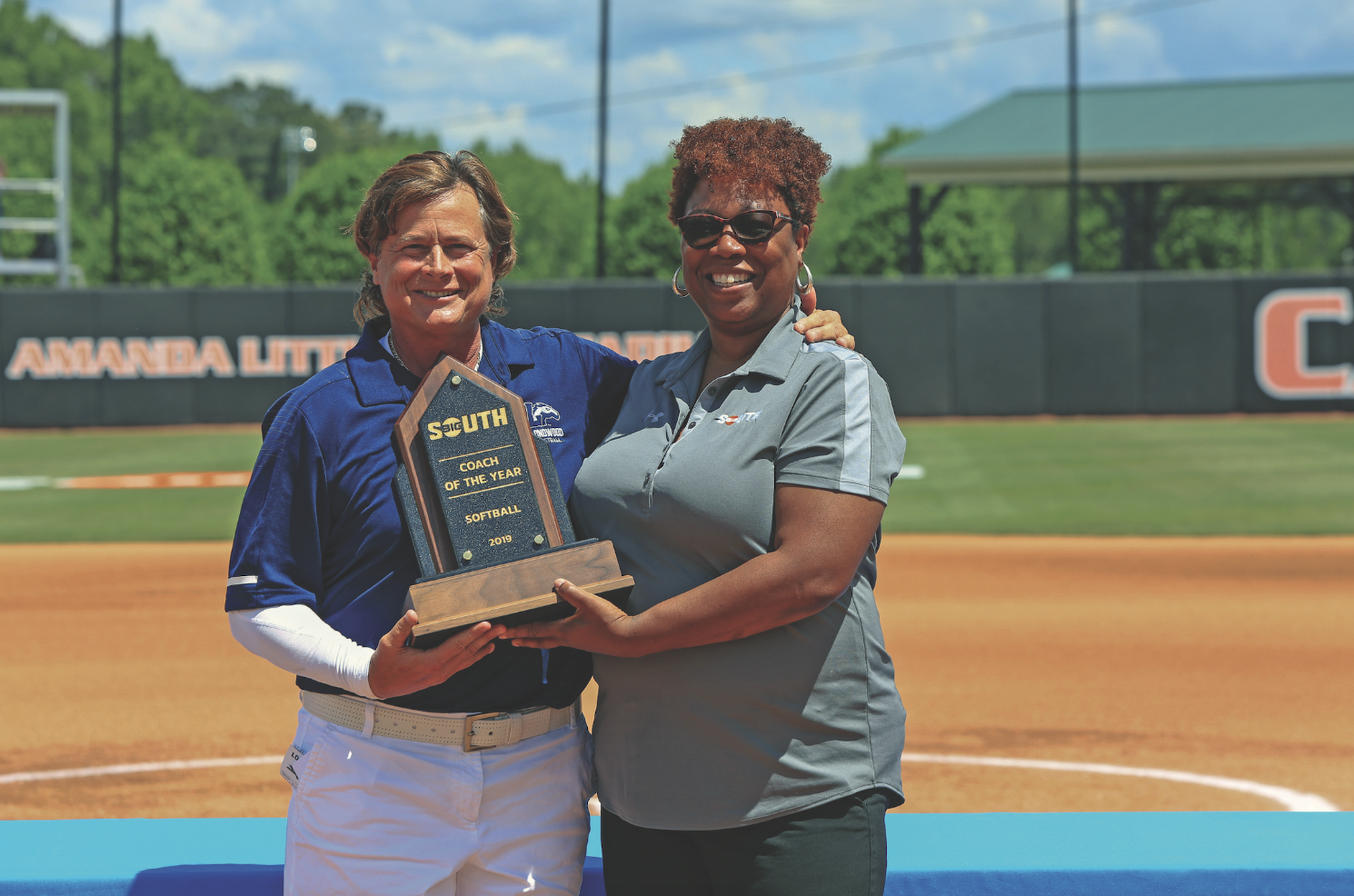 Softball coach Kathy Riley (left)