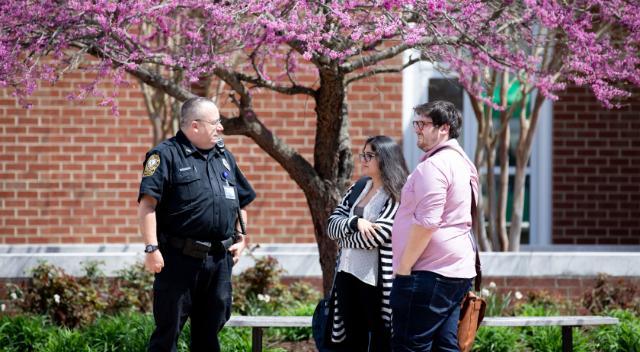 Police officer talking to students on Brock Commons