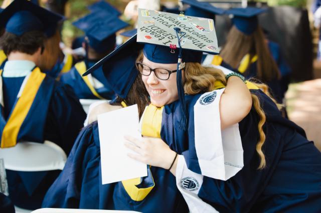 Students hug during the commencement ceremony