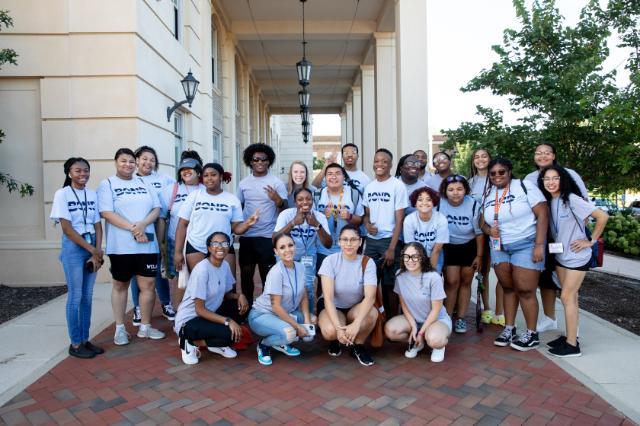 BOND students and mentors posing outside Johns and Moss