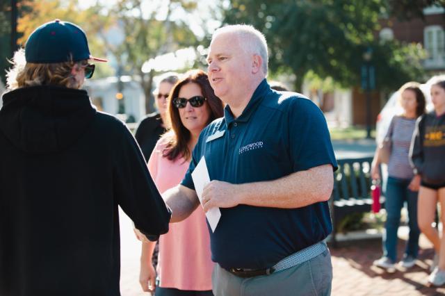 Jason “Ferg” Ferguson talks to family members at an admissions event