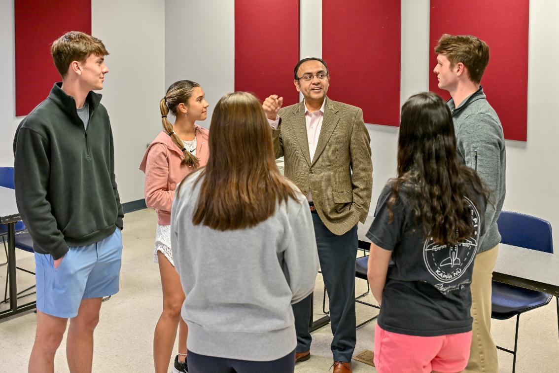 Dr. Khawaja Mamun talks with members of the Lancer Student Investment Fund