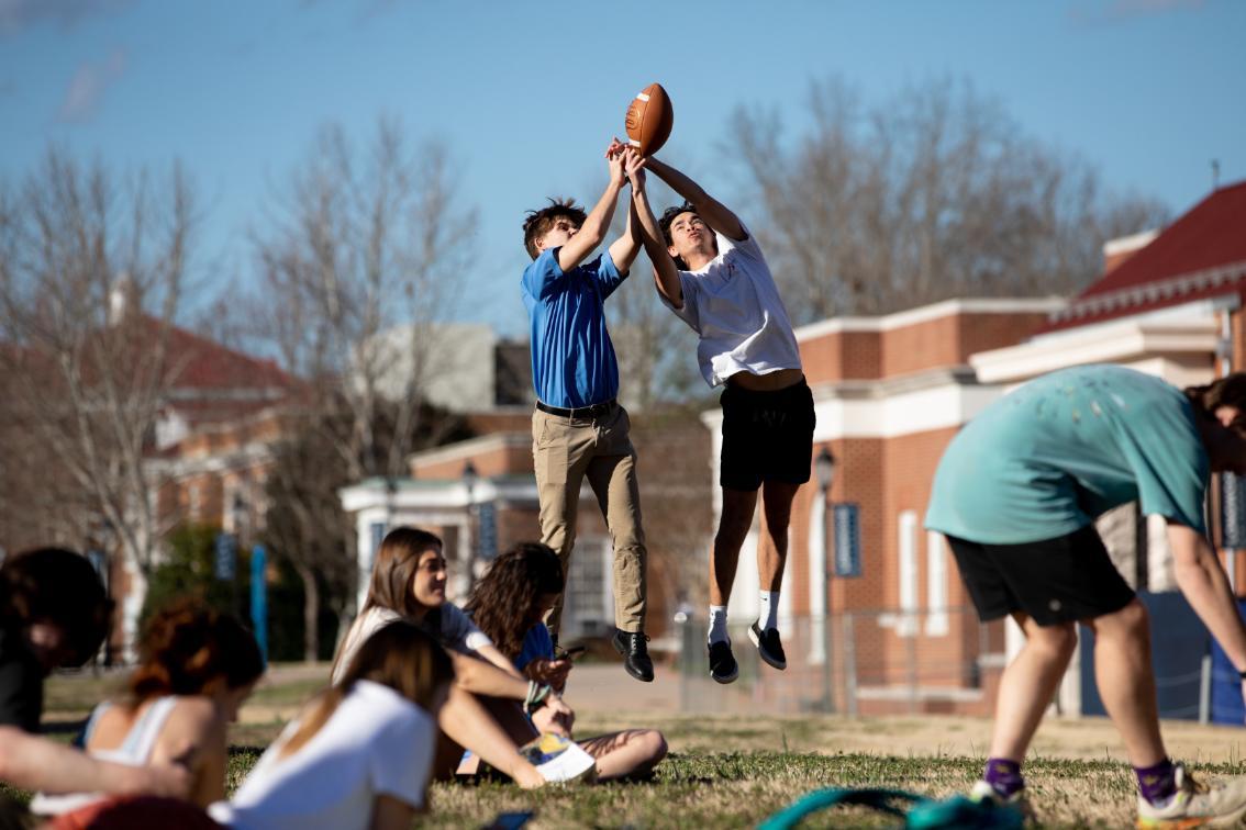 Students playing football on Brock Commons