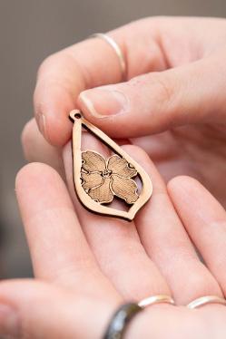 Megan Brown ’26 drew the design of her earrings, which feature a cosmos flower